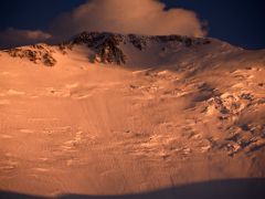 06B Lenin Peak summit area shines orange at sunset from Ak-Sai Travel Lenin Peak Camp 1 4400m